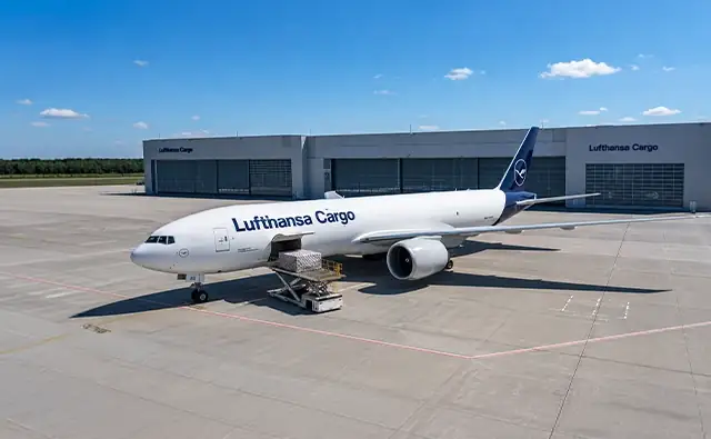 Lufthansa Cargo freight aircraft on a runway at sunset. Image represents global logistics solutions and efficient air cargo logistics.