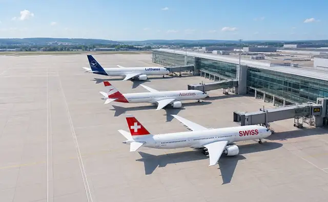 Aircraft of various airlines of the Lufthansa Group with visible tail fins on the tarmac.