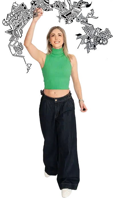 Julia Gorton draws sweeping black doodles in the air, wears a green crop top and dark jeans - creative, energetic, and full of expression.