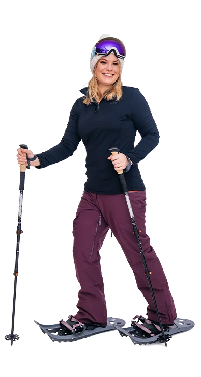 Sophie Scharf on the way in the snow with snowshoes, winter clothing and ski goggles - athletic, cheerful, and ready for winter excursions.